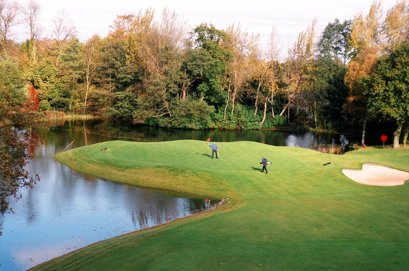 Little Aston Golf Club signature water hole with green, bunker and mature parkland