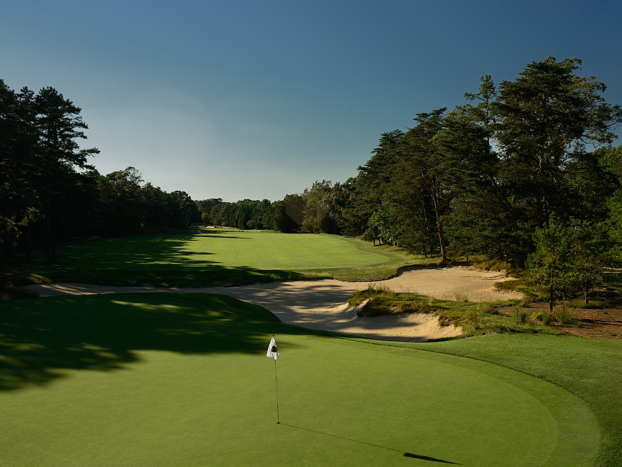 Pine Valley Golf Club course with green, fairway, sand and pine trees